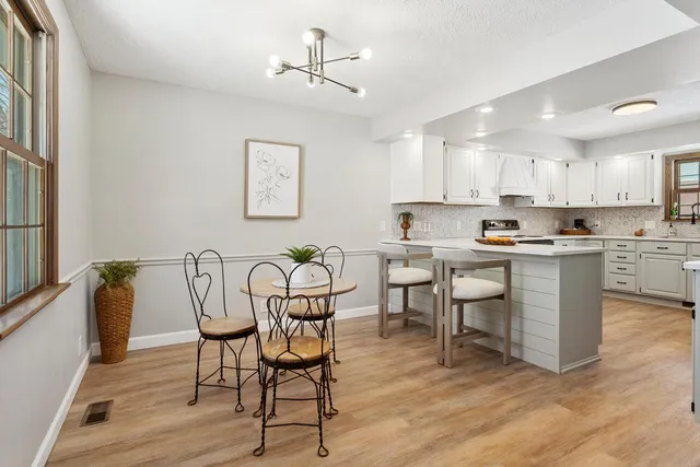 a view of kitchen with cabinets table and chairs