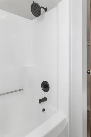 a white toilet sitting next to a shower curtain