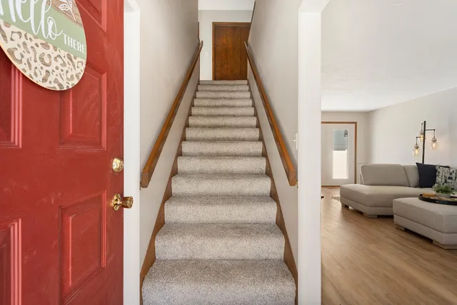 a view of entryway and hall with wooden floor