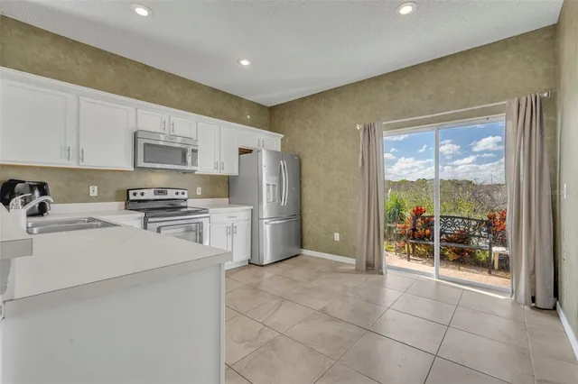 a kitchen with stainless steel appliances a refrigerator sink and cabinets