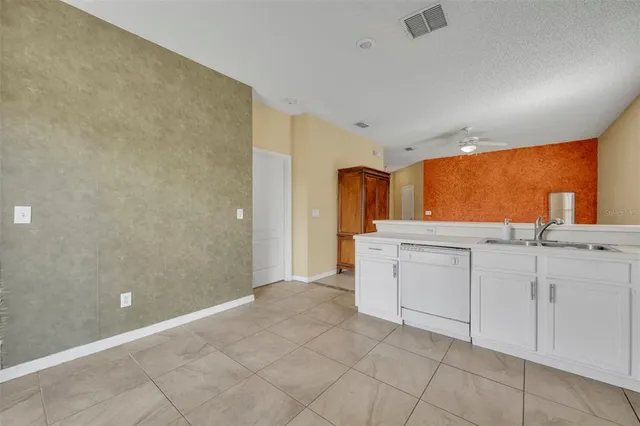 a view of a kitchen with white cabinets
