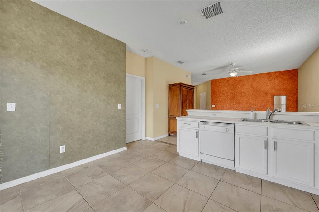 4718 Waterside Pointe Circle Orlando, FL 32829 - Photo 14 of 30 a view of a kitchen with white cabinets