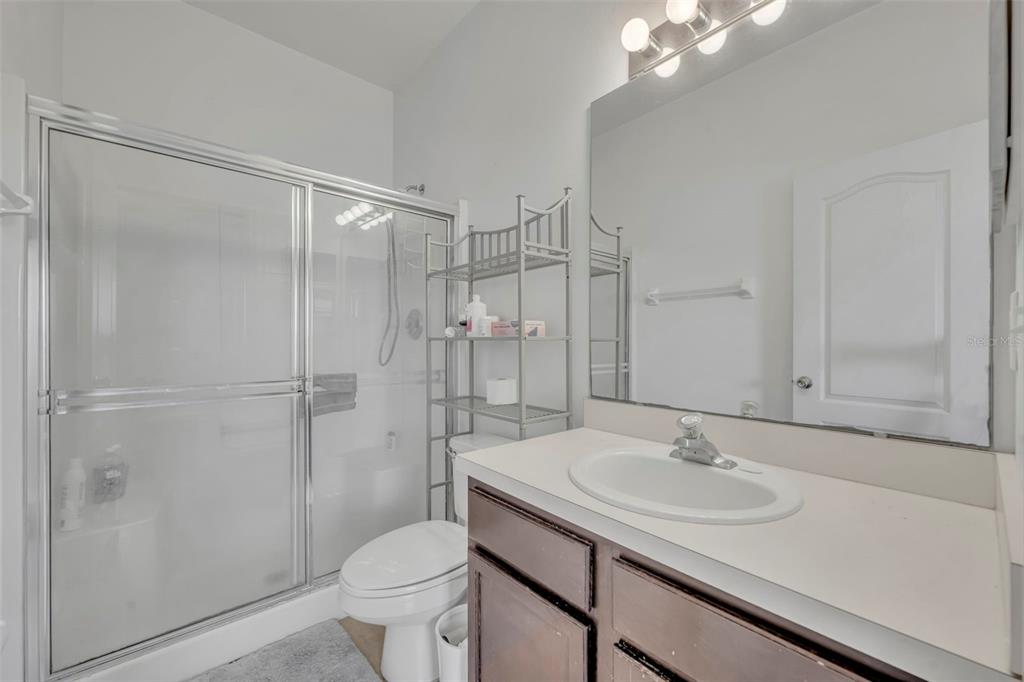 4718 Waterside Pointe Circle Orlando, FL 32829 - Photo 17 of 30 a bathroom with a sink toilet and shower