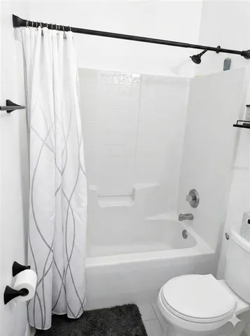 a bathroom with a toilet and a bathtub