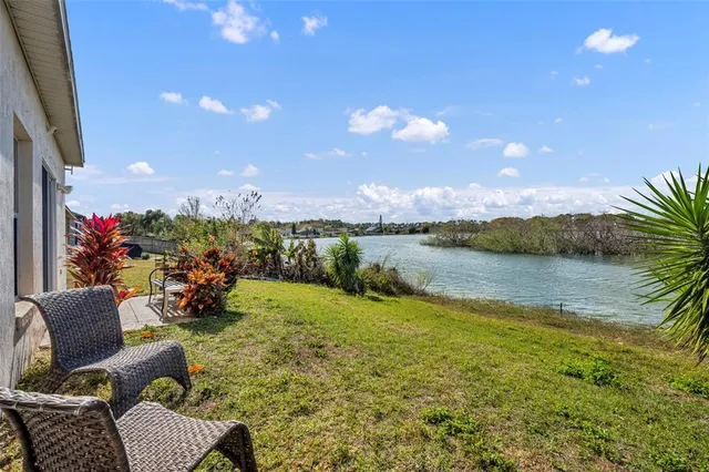 a view of a lake with couches and city view
