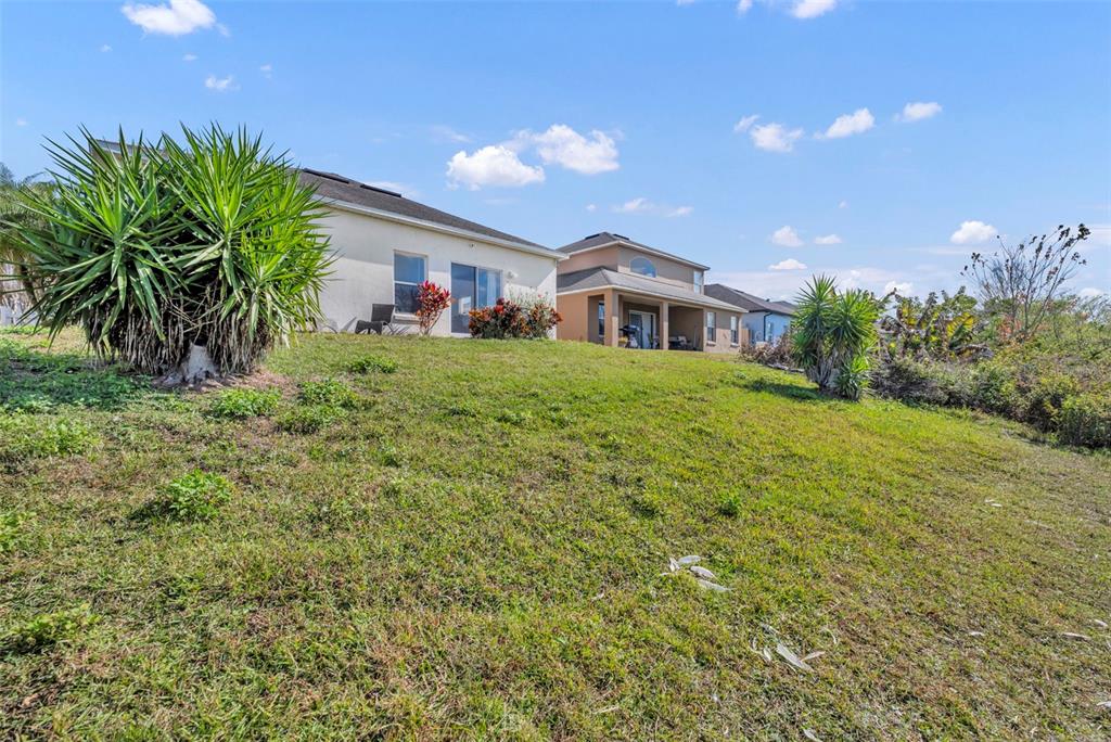 4718 Waterside Pointe Circle Orlando, FL 32829 - Photo 26 of 30 a front view of a house with a garden