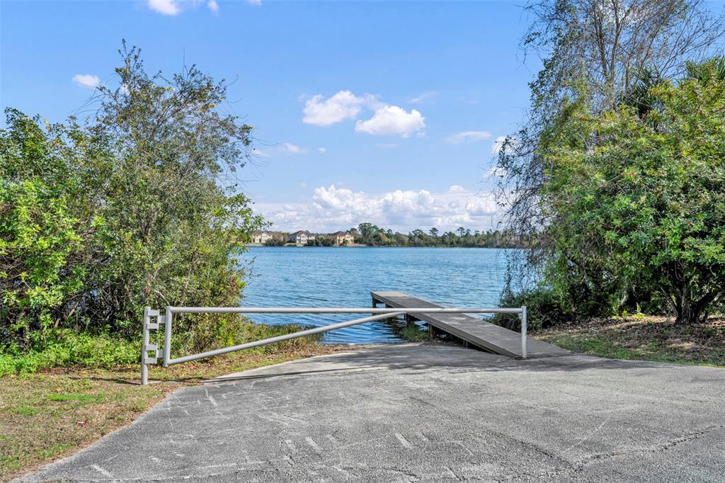 4718 Waterside Pointe Circle Orlando, FL 32829 - Photo 28 of 30 a view of a bench in a yard