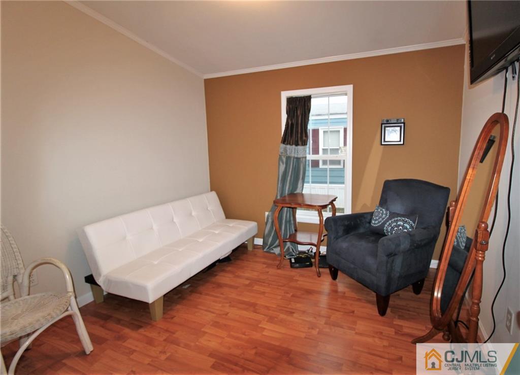 19 Poe Road, Unit 19 North Brunswick, NJ 08902 - Photo 14 of 17 a living room with furniture and a window
