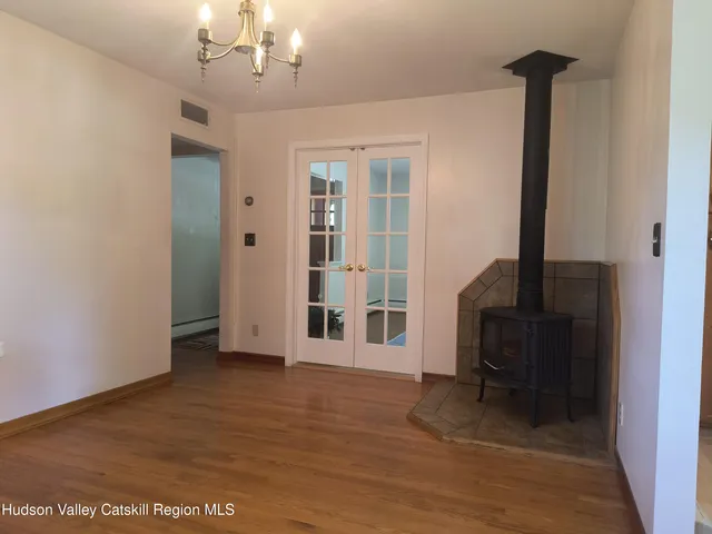 a view of a livingroom with a furniture wooden floor and a window