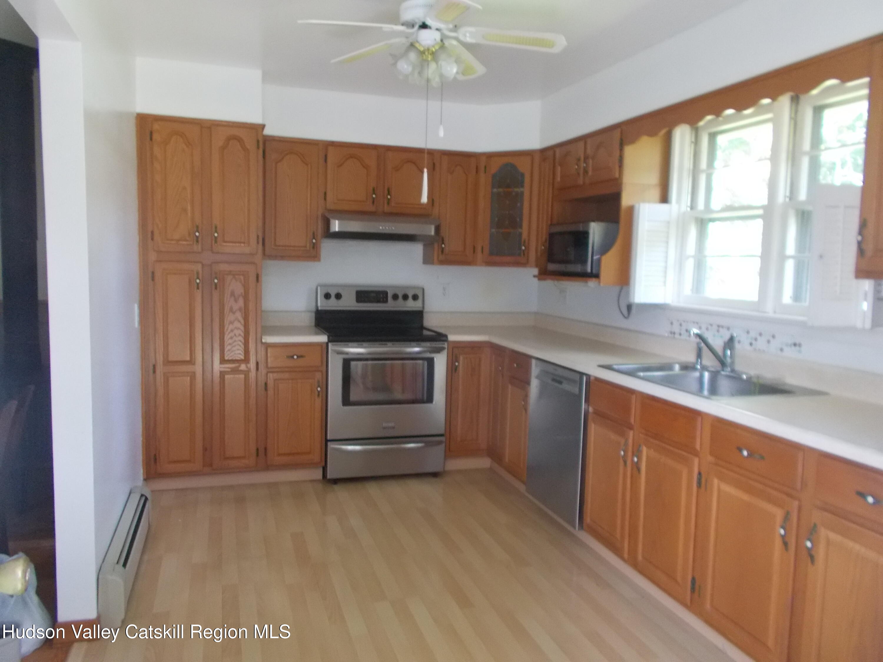 14 Strawberry Hill Road Poughkeepsie, NY 12601 - Photo 22 of 48 a kitchen with stainless steel appliances a sink cabinets and a window