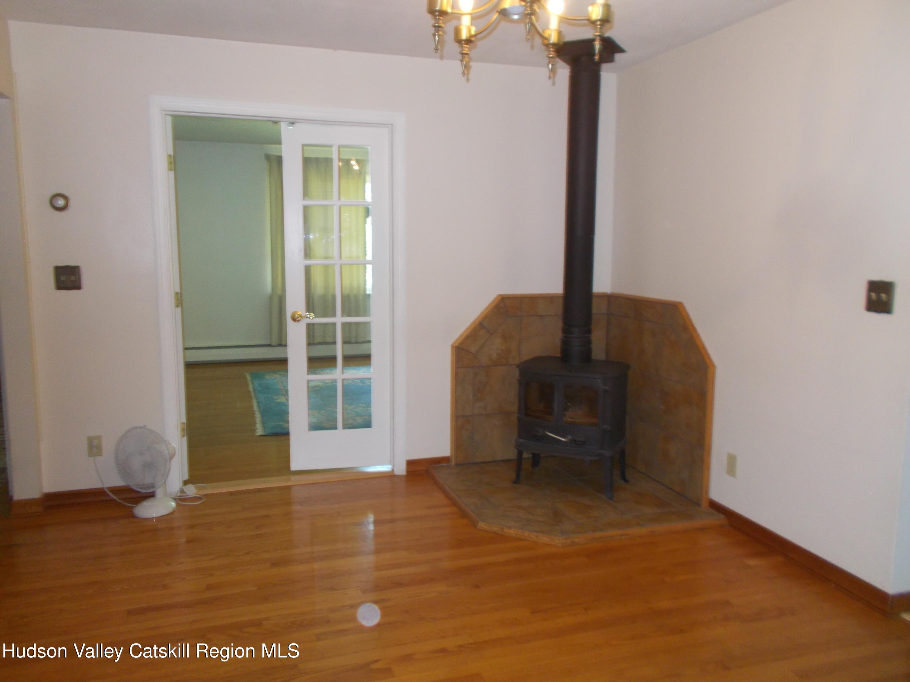 14 Strawberry Hill Road Poughkeepsie, NY 12601 - Photo 23 of 48 a view of an empty room with a window and wooden floor