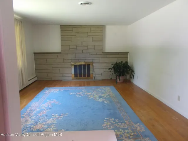 a view of empty room with a fireplace