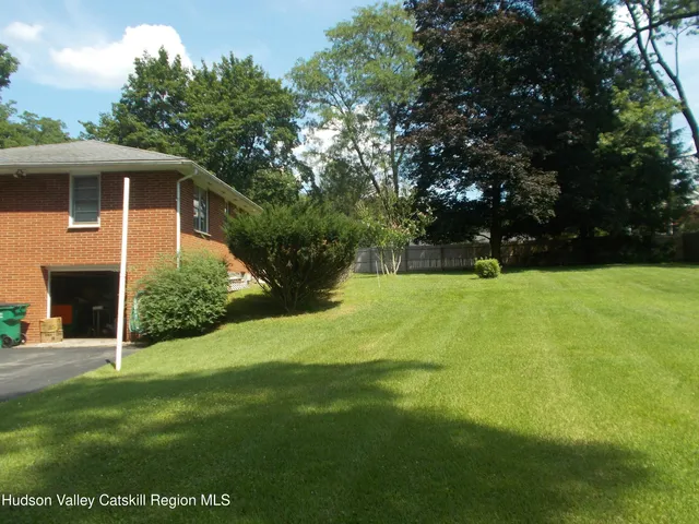 a view of an house with backyard space and garden
