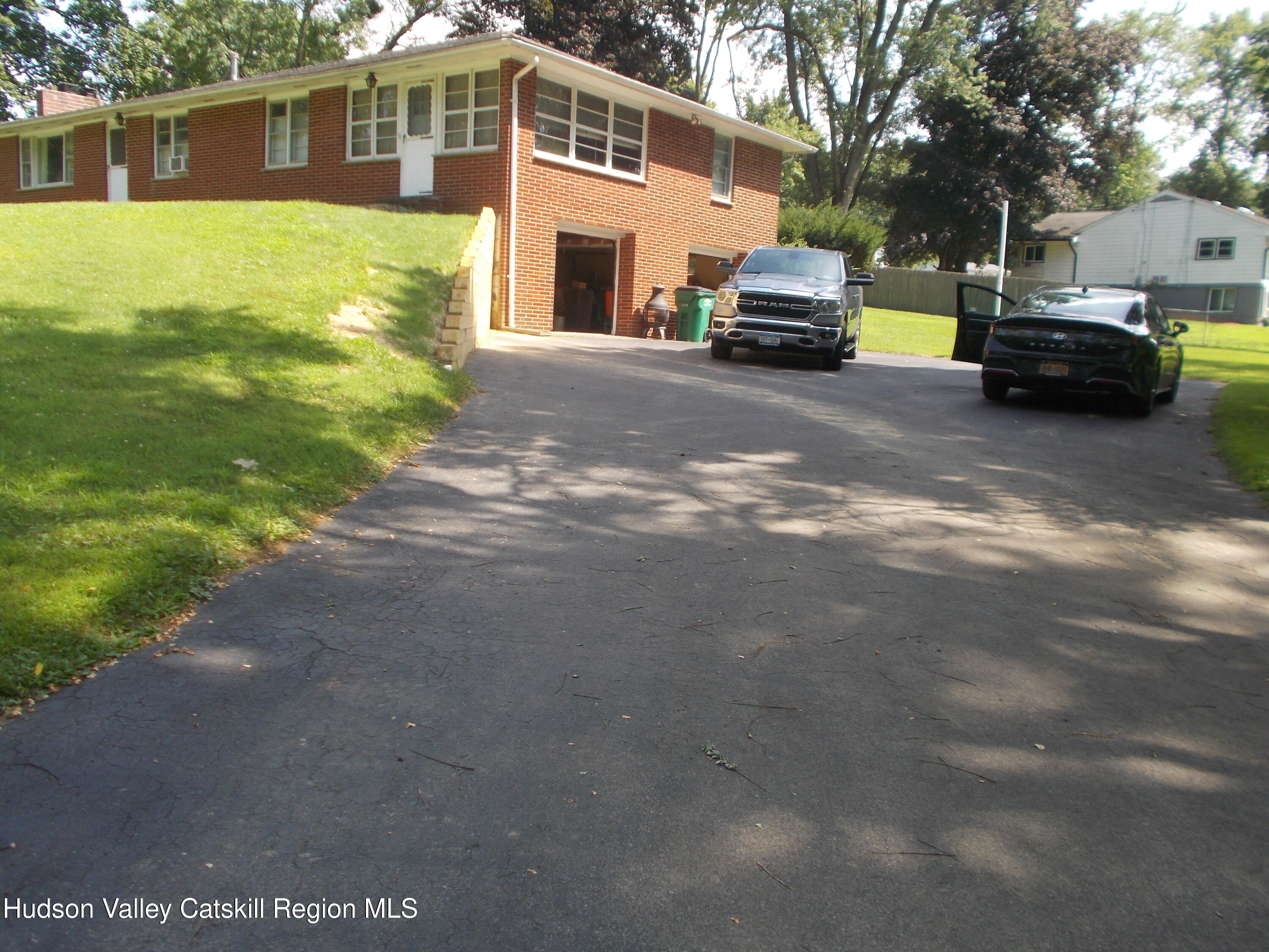 14 Strawberry Hill Road Poughkeepsie, NY 12601 - Photo 44 of 48 a front view of a house with a garden and parking space