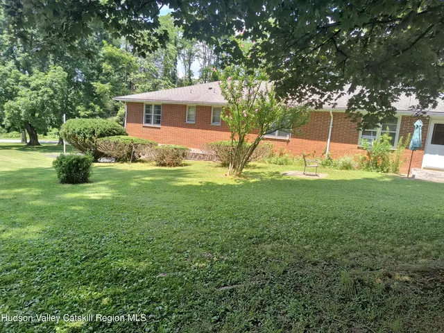 a view of a house with a backyard