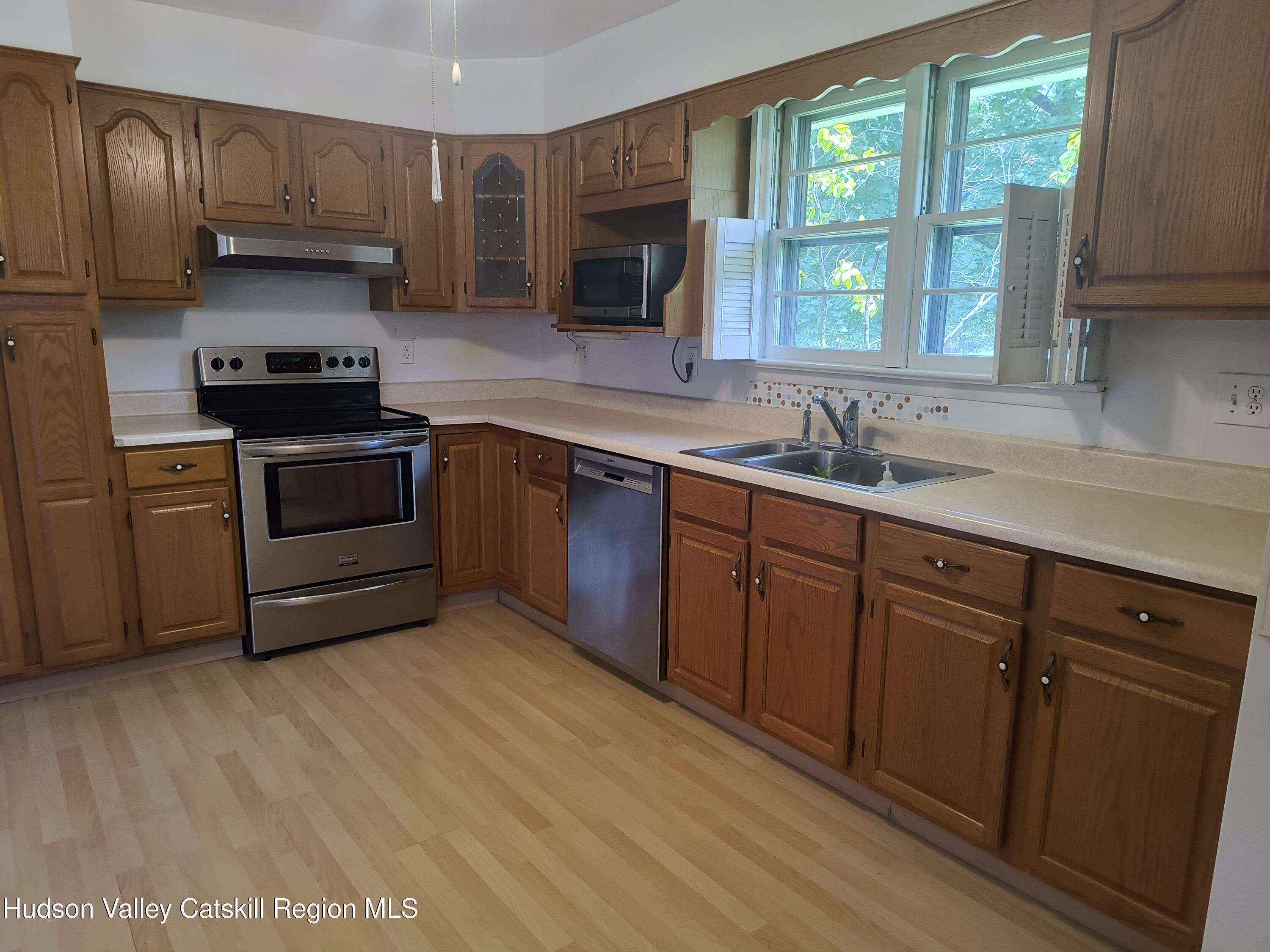 14 Strawberry Hill Road Poughkeepsie, NY 12601 - Photo 9 of 48 a kitchen with granite countertop a stove a sink and a microwave