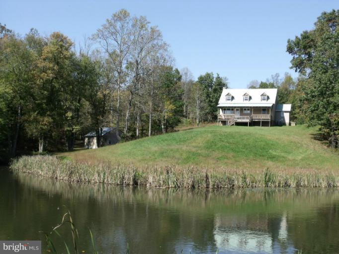 7037 Olinger Road Marshall, VA 20115 - Photo 1 of 30 a view of a lake with houses