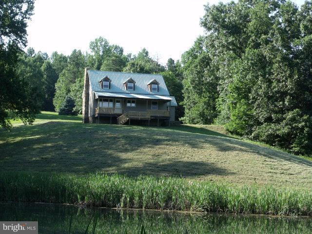 7037 Olinger Road Marshall, VA 20115 - Photo 3 of 30 a view of a big house with a big yard and large trees