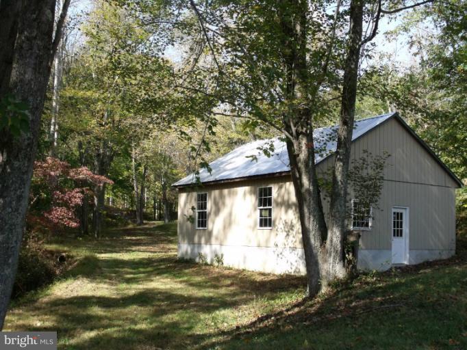 7037 Olinger Road Marshall, VA 20115 - Photo 23 of 30 a view of a house with backyard and tree