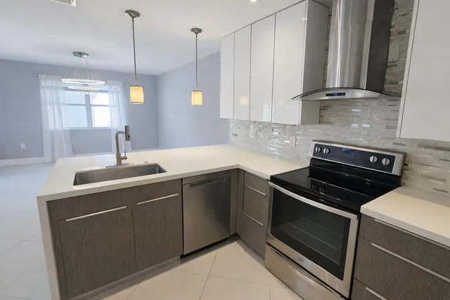 a kitchen with a sink stove and cabinets
