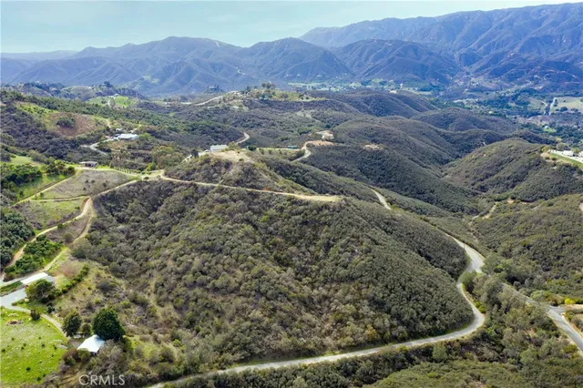 a view of a yard with wooden fence