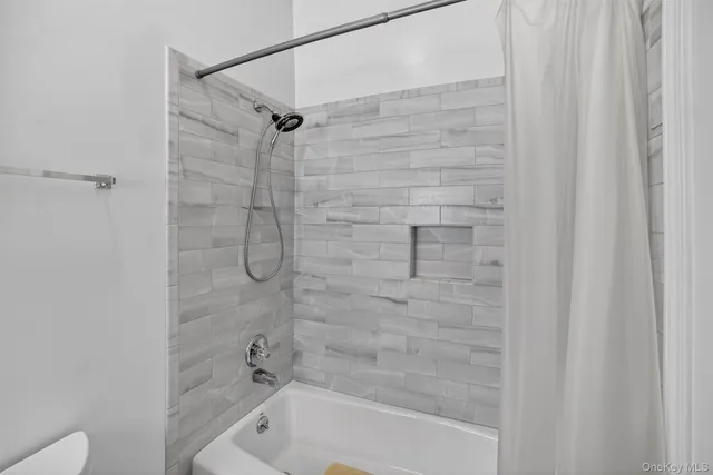 a view of an empty room with stairs and furniture