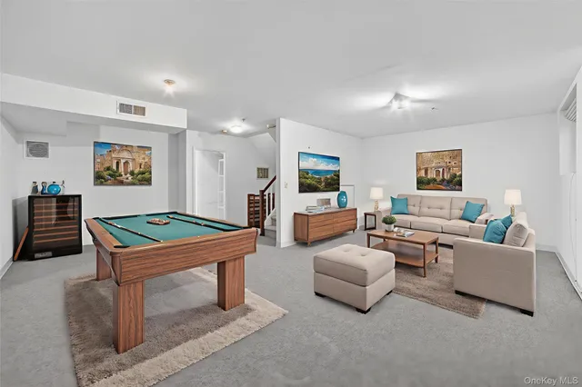 a view of roof deck with two couches and wooden fence