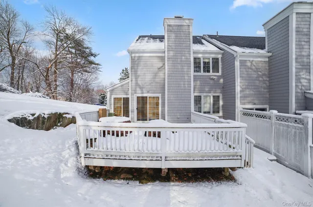a view of backyard with deck and outdoor seating