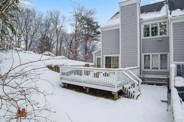 a view of a house with a wooden deck