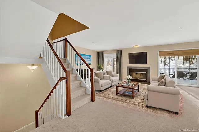 a living room with furniture or stairs and a flat screen tv