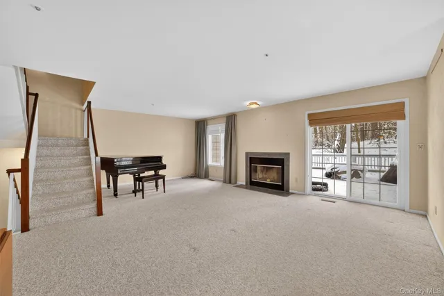 a view of empty room with furniture and fireplace