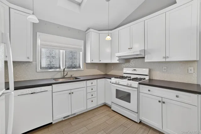 a kitchen with stove and cabinets