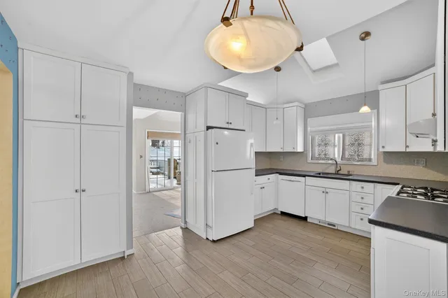 a kitchen with granite countertop a sink stainless steel appliances and cabinets