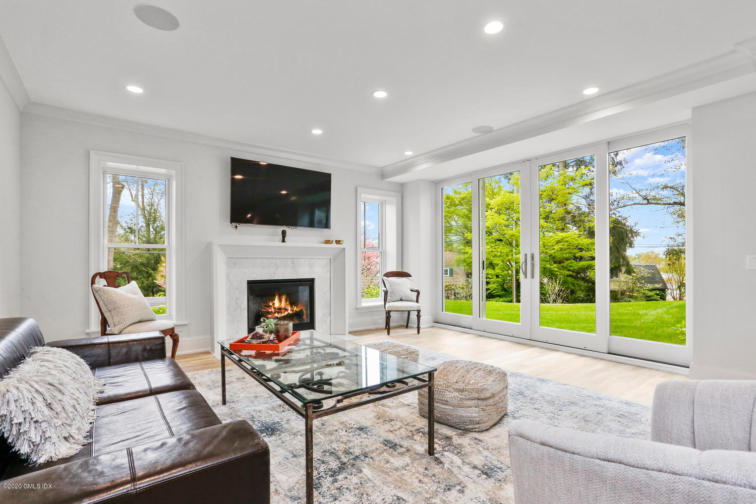 6 Perkley Lane Riverside, CT 06878 - Photo 31 of 52 a living room with furniture a fireplace and a flat screen tv
