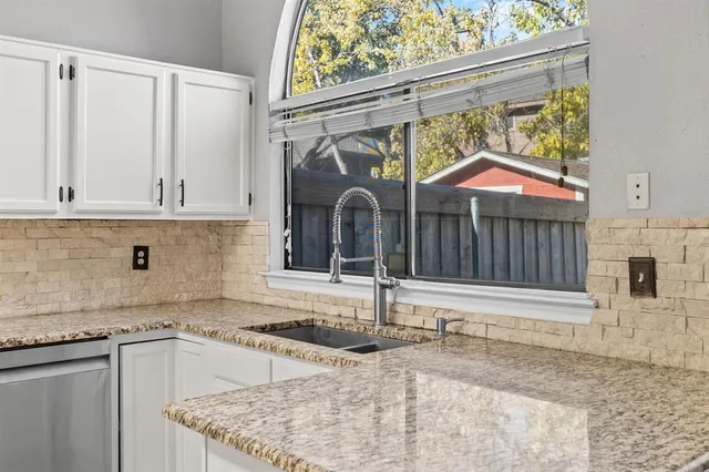 a kitchen with stainless steel appliances granite countertop a sink and a granite counter tops