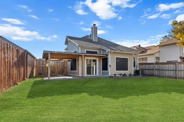 a view of a house with a yard and porch