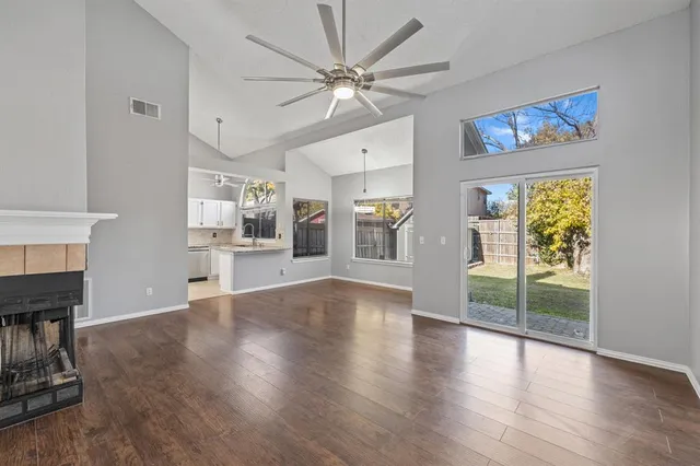 a living room with wooden floors and a fireplace