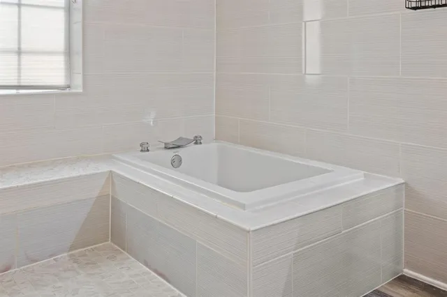 a white bath tub sitting next to a white sink