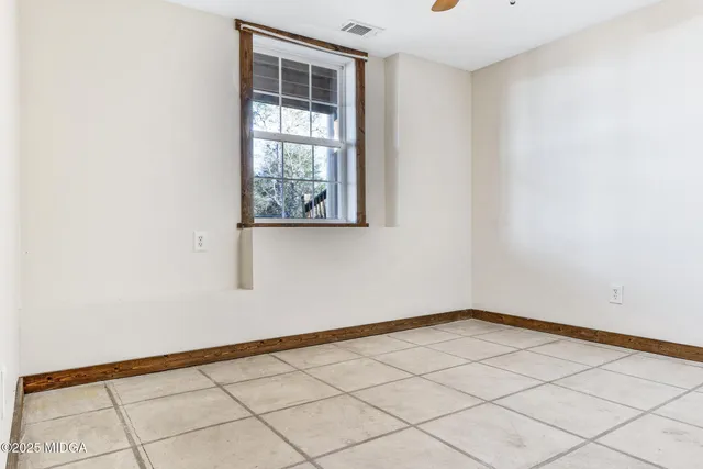 a view of a bench in the roof deck with wooden fence