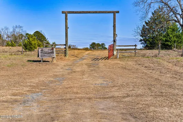 a view of a yard with wooden fence