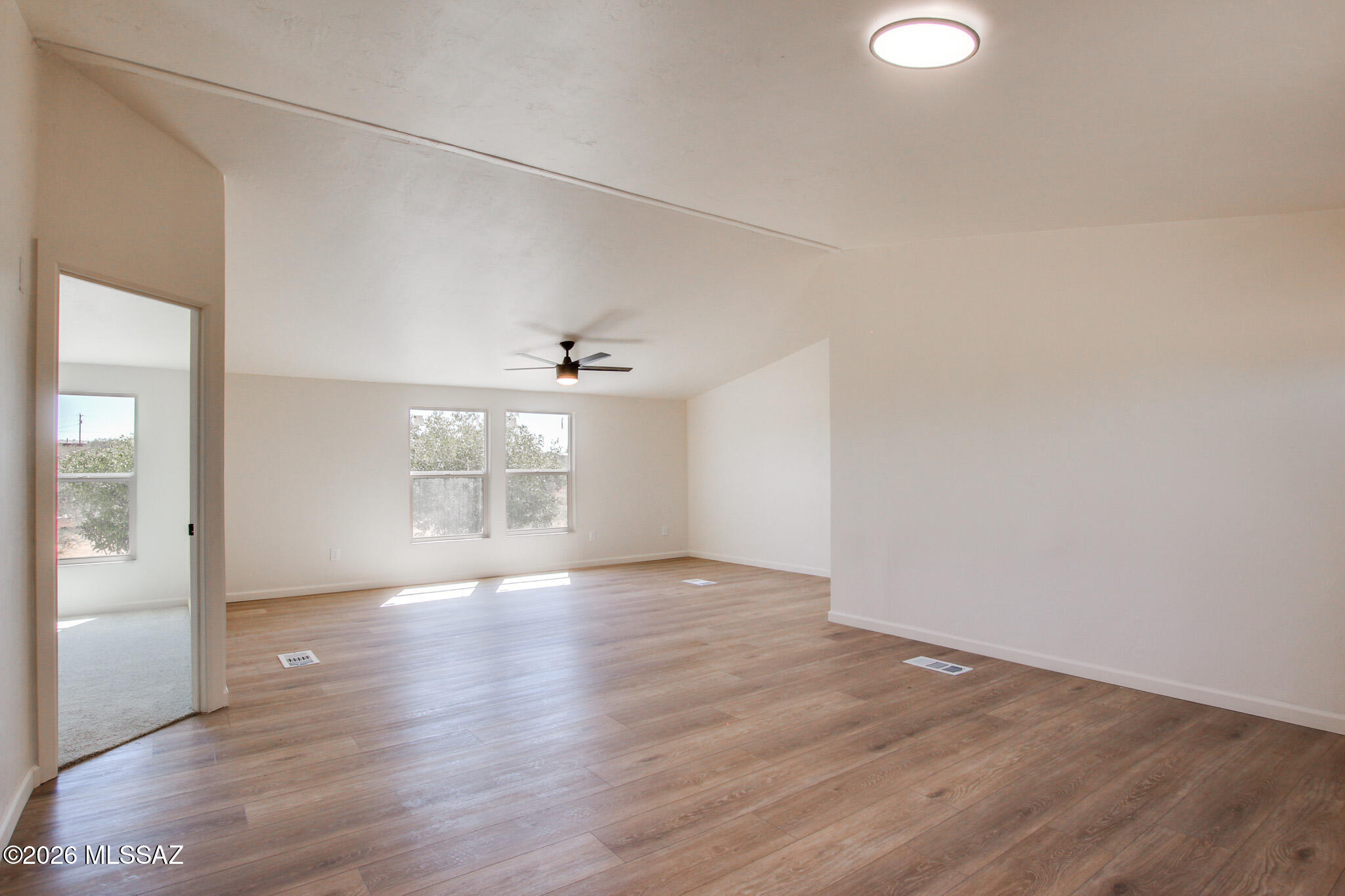 14303 West Rolina Lane Tucson, AZ 85736 - Photo 9 of 38 a view of an empty room with a window and wooden floor