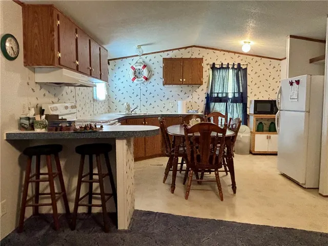 a living room with furniture and a dining table