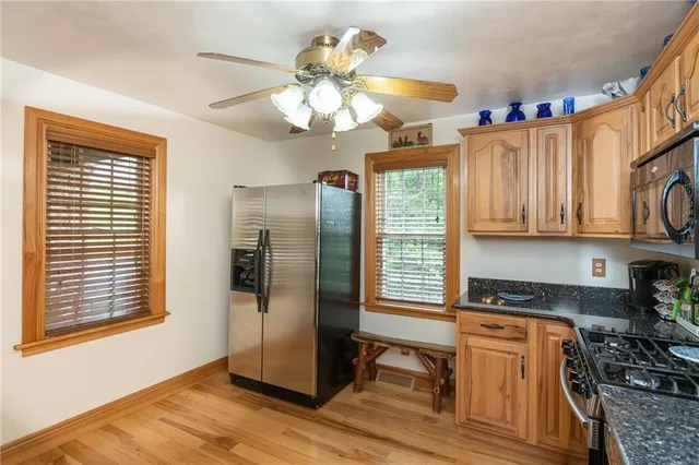 a kitchen with stainless steel appliances granite countertop a refrigerator a oven a sink and dishwasher