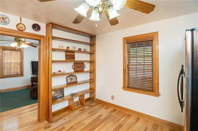 a view of a livingroom with wooden floor and windows