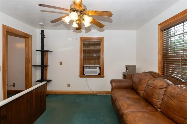 a living room with furniture chandelier and a window