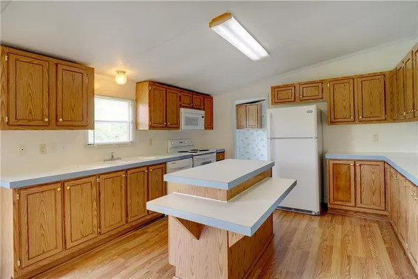 a kitchen that has a sink and a stove top oven