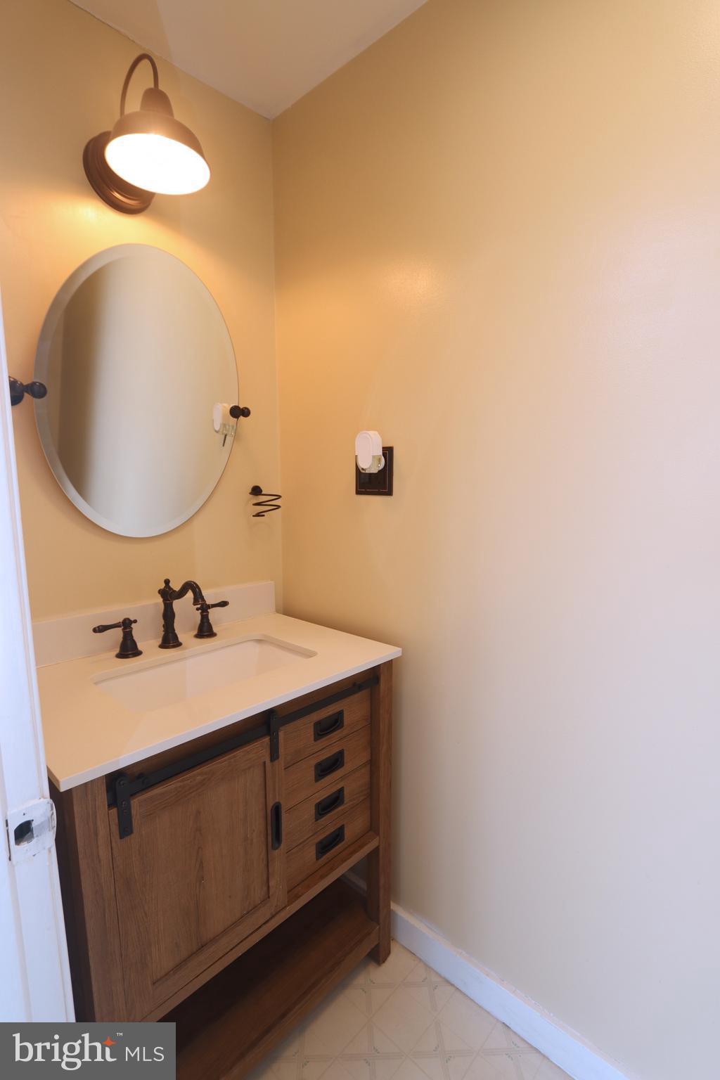 1012 Wells Street Conshohocken, PA 19428 - Photo 14 of 29 a bathroom with a sink and a mirror