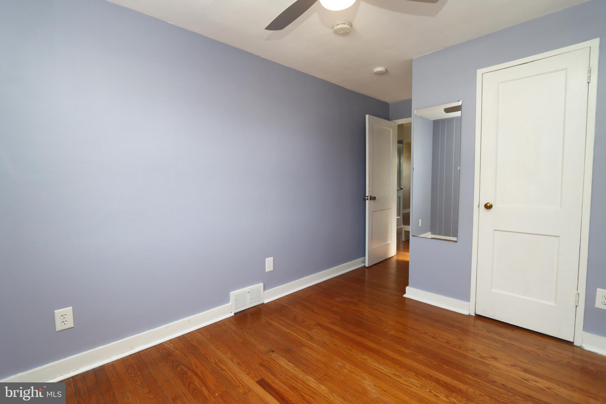 1012 Wells Street Conshohocken, PA 19428 - Photo 20 of 29 an empty room with wooden floor and a ceiling fan