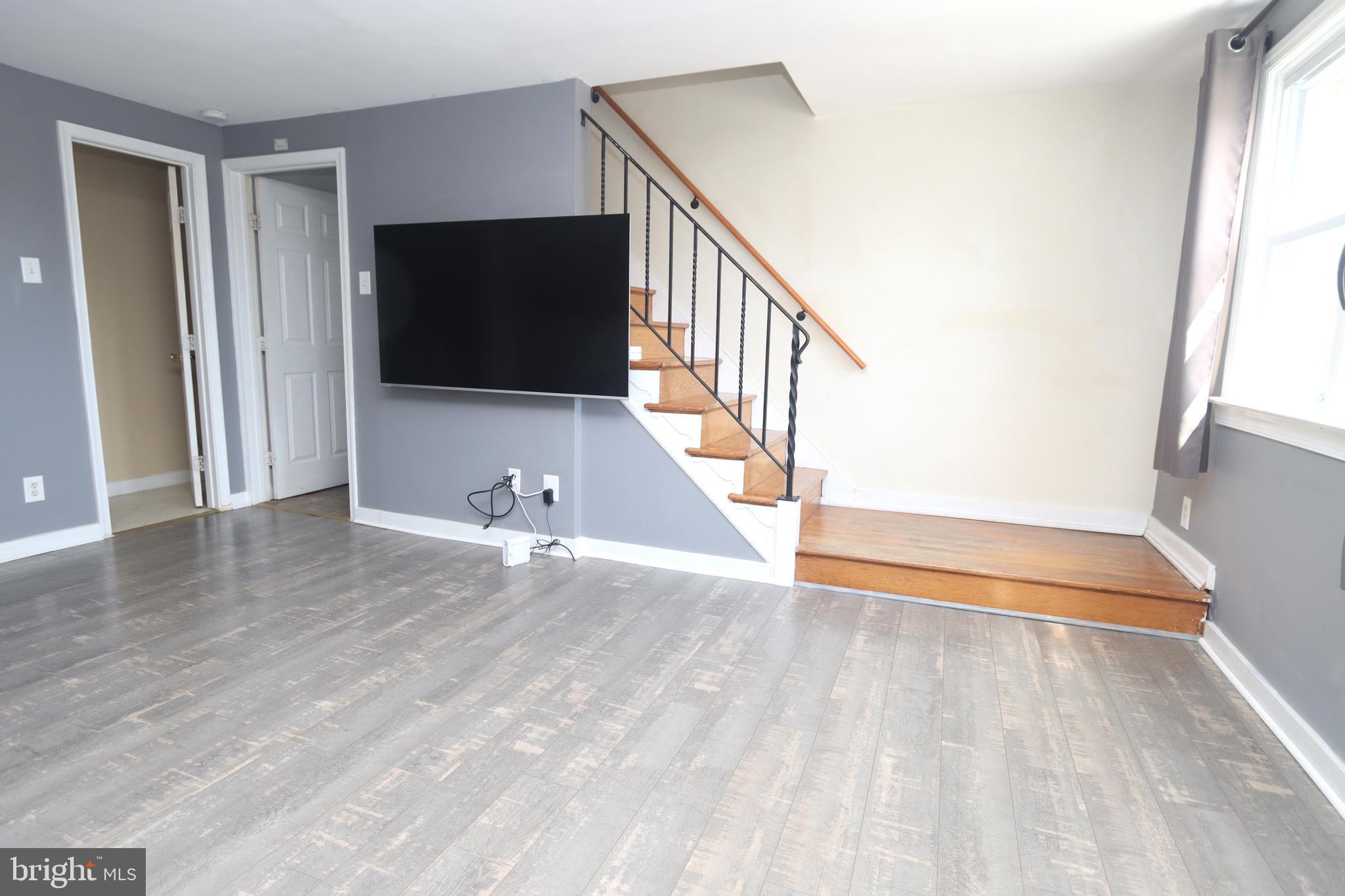 1012 Wells Street Conshohocken, PA 19428 - Photo 5 of 29 a view of a livingroom with wooden floor and staircase