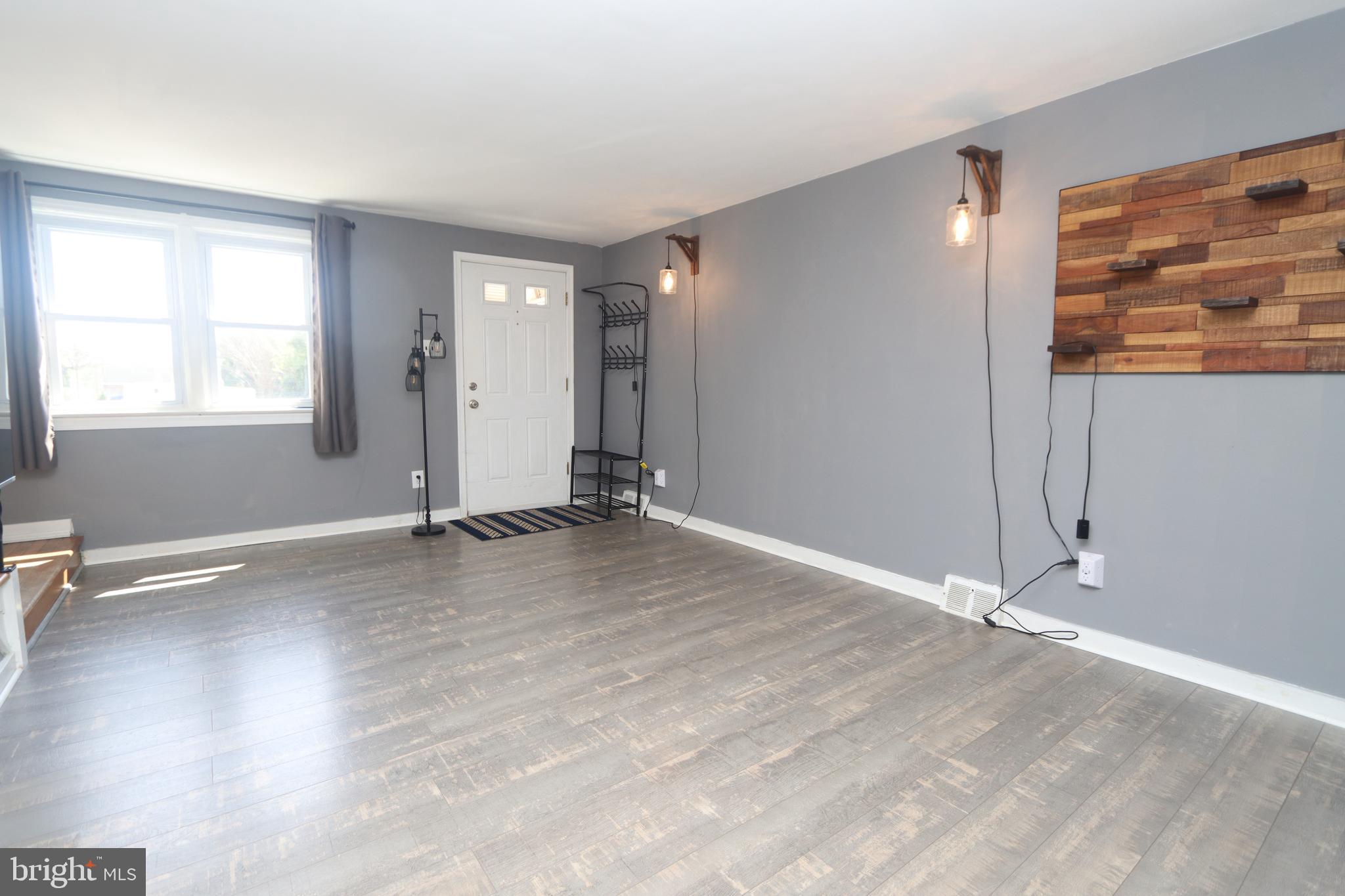 1012 Wells Street Conshohocken, PA 19428 - Photo 7 of 29 an empty room with wooden floor and windows